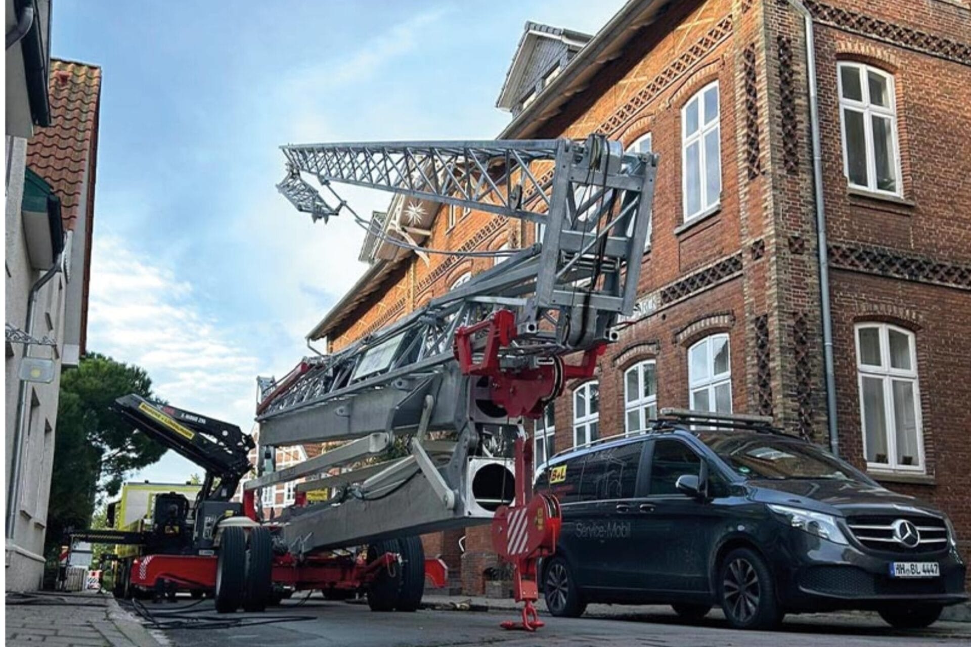 Schnellmontagekran zusammengeklappt zwischen Häusern in einer Straße. 